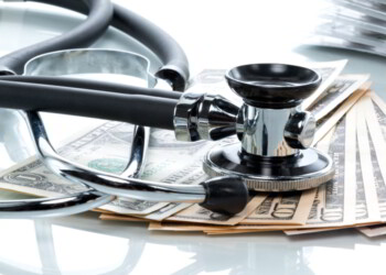 Dollar bills with stethoscope. Cost Of Healthcare Overseas