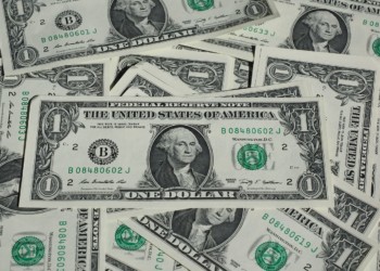 a messy pile of dollar bills