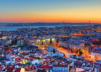 aerial view of rooftops, buildings and bridge in Lisbon Portugal