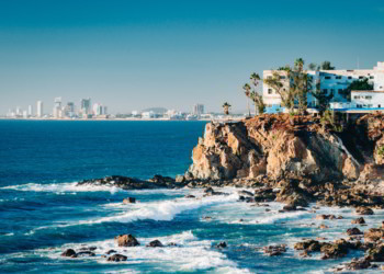 Mazatlan as seen from afar with a spectacular cliff line in the foreground