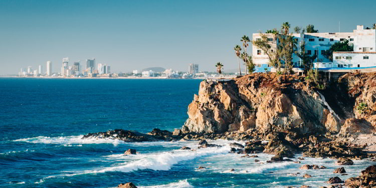 Mazatlan as seen from afar with a spectacular cliff line in the foreground