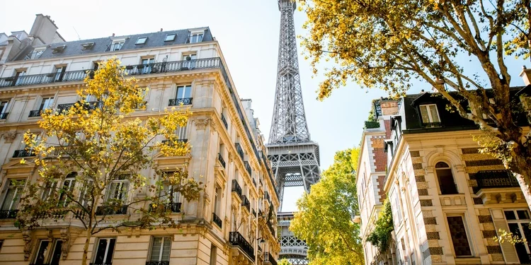 Beautiful street view with old residential buildings and Eiffel tower during the daylight in Paris France