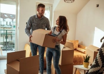 Couple Moving House, holding boxes