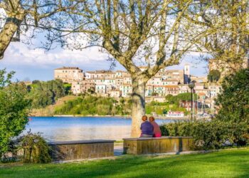 Ladies chatting on river shore in Italy.