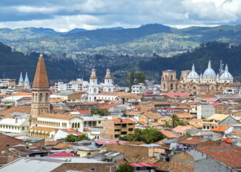 View of the city of Cuenca, Ecuador, with its many churches and rooftops, on a cloudy day