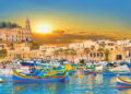 Marsaxlokk bay harbour of Malta, with beautiful architecture and boats at dusk