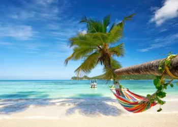 sunny beach with a hammock. How To Retire Overseas