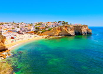 A town in the Algarve, Portugal right next to a bright blue ocean