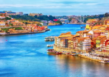 Porto, Portugal old town ribeira aerial promenade view with colorful houses, Douro river and boats