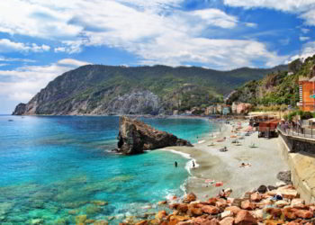 A quaint little town in Italy with bright blue waters and colorful buildings