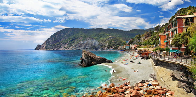 A quaint little town in Italy with bright blue waters and colorful buildings