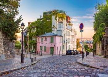 Cozy old street with pink house at the sunny sunrise, quarter Montmartre in Paris, France