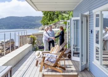 Real estate agent showing property to senior couple