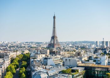 Aerial view of the old town of Paris, with the building of Eiffel tower, from the top of the Arc de Triomphe at the Champs-Elysees Avenue in Paris, France.