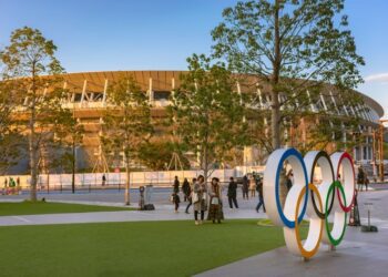 Olympic Rings monument on the Japan sport Olympic square of Japan Olympic Museum with the Olympic stadium in background.