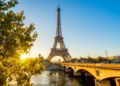 A view of Paris with the Seine River and the Eiffel tower in the background on a sunny afternoon. How To Leave The US