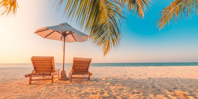 White sand and coco palms on a beautiful sea and bright blue sky