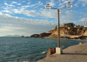 A lamp post next to the blue ocean in Mazatlan, Mexico