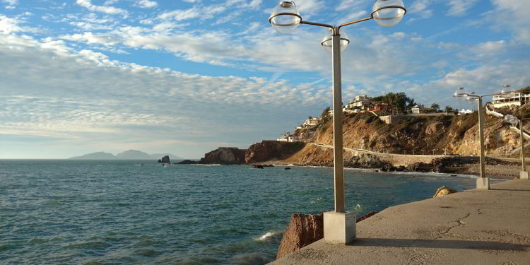 A lamp post next to the blue ocean in Mazatlan, Mexico