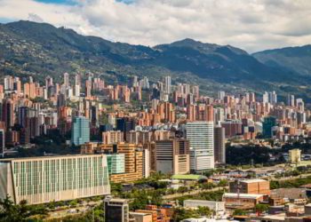 A view of the buildings of Medellin with mountains in the background