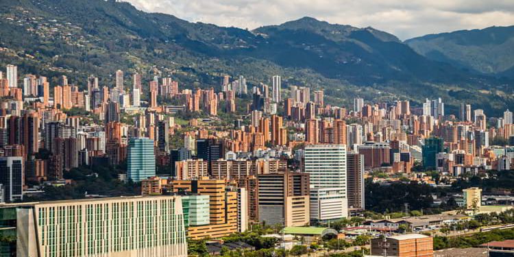 A view of the buildings of Medellin with mountains in the background