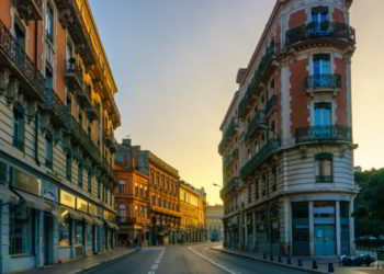 Narrow historic street with old buildings in Toulouse, France