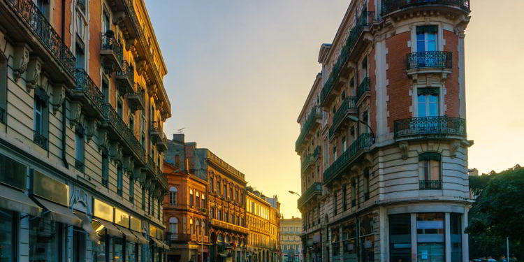 Narrow historic street with old buildings in Toulouse, France