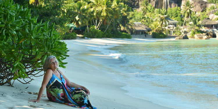 Portrait of happy elderly woman on beach