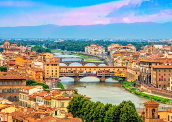 Panoramic view of medieval stone bridge Ponte Vecchio over Arno river in Florence, Tuscany, Italy