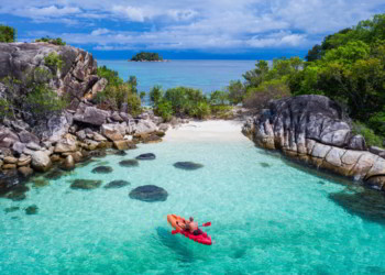 Aerial drone view of in kayak in crystal clear lagoon sea water during summer day near Koh Lipe island in Thailand