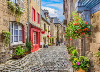 Idyllic scene of traditional houses in narrow alley in an old town in Europe