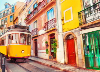 Yellow vintage tram on the street in Lisbon, Portugal.