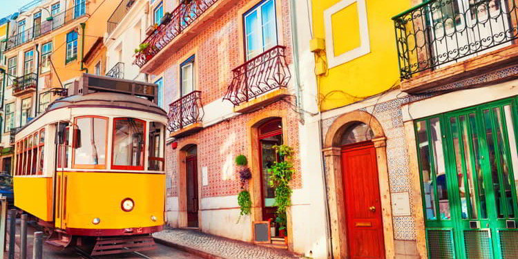 Yellow vintage tram on the street in Lisbon, Portugal.