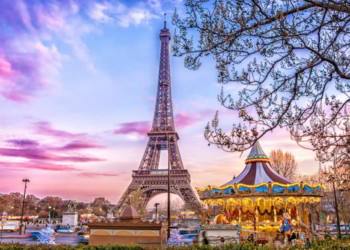 The Eiffel Tower and vintage carousel on a winter evening in Paris, France retire overseas