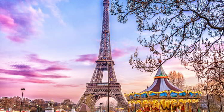 The Eiffel Tower and vintage carousel on a winter evening in Paris, France retire overseas