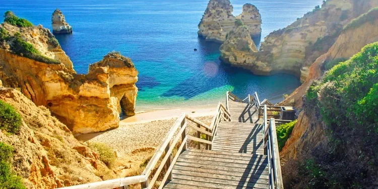 Wooden footbridge to beautiful beach Praia do Camilo near Lagos, Portugal