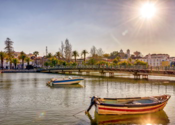 Colorful boats on Gilao river in picturesque Tavira, Portugal