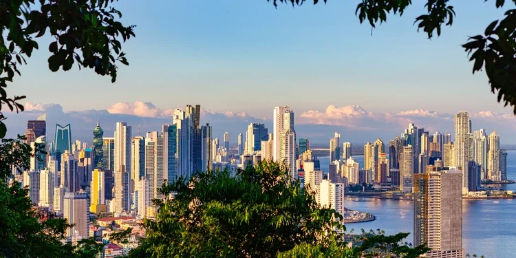 View of Panama City's skyline framed by a tropical rainforest.