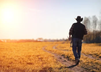 a man with cowboy hat and lasso