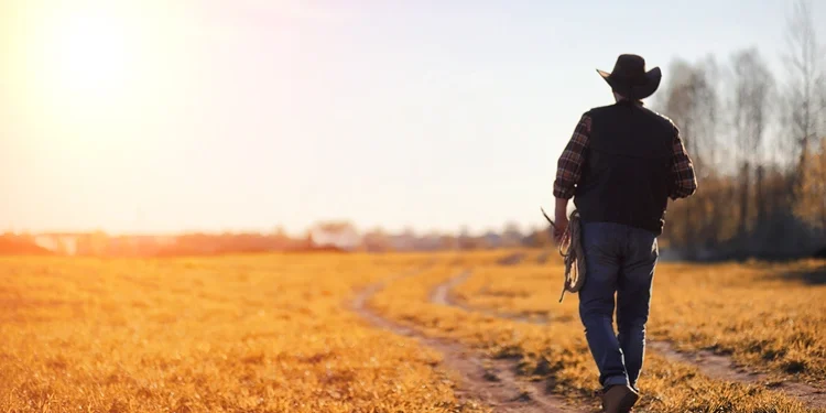 a man with cowboy hat and lasso