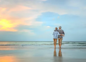 Senior couple walking on the beach. Are You Ready To “Retire Up”? wealthy Panama vs Belize