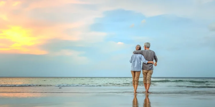 Senior couple walking on the beach. Are You Ready To “Retire Up”? wealthy Panama vs Belize