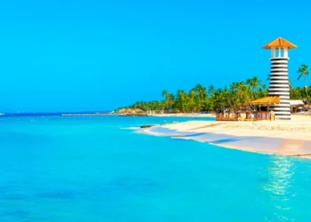 Panoramic view of the tropical beach with lighthouse in Dominican Republic. cost of living