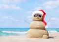 Tropical beach and snowman figure made with sand