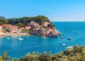 Picturesque summer view of Adriatic sea coast in Budva Riviera. Przno village with buildings on the rock, Montenegro