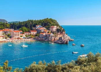 Picturesque summer view of Adriatic sea coast in Budva Riviera. Przno village with buildings on the rock, Montenegro