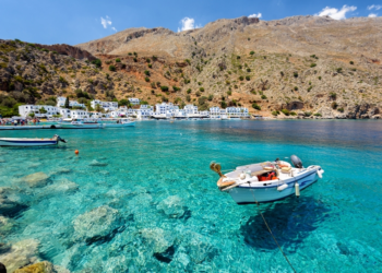 Small motorboat at clear water bay of Loutro town on Crete island, Greece