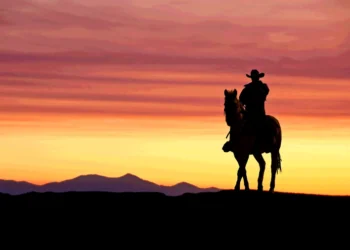 cowboy on horse at sunset in the American West