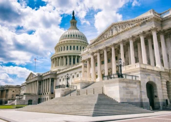 Bright mid-day view of the Capitol Building’s dome, columns, and steps in Washington DC