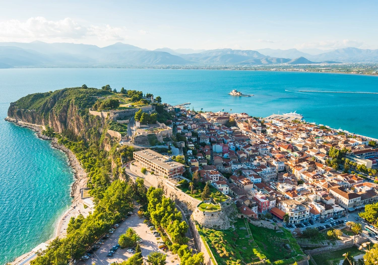 Aerial view of a green peninsula with small houses in Nafplio Greece